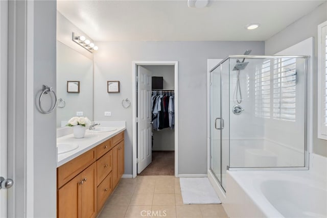 bathroom with tile patterned flooring, plus walk in shower, and vanity