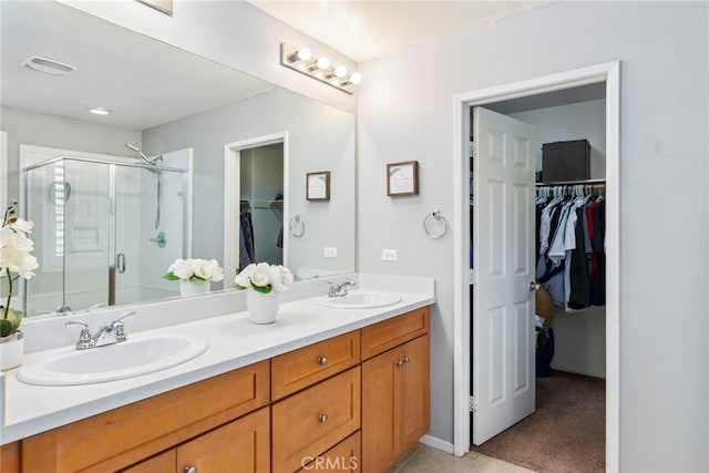 bathroom featuring an enclosed shower and vanity