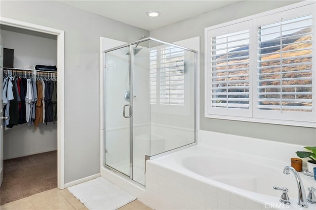 bathroom featuring tile patterned flooring and shower with separate bathtub