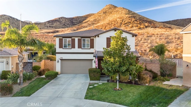 view of front of property featuring a front yard, a garage, and a mountain view