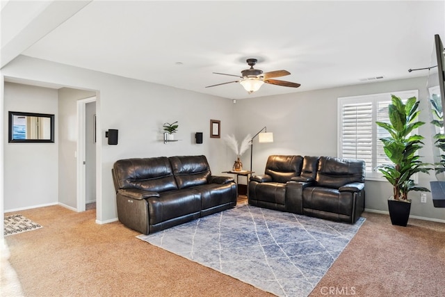 carpeted living room featuring ceiling fan