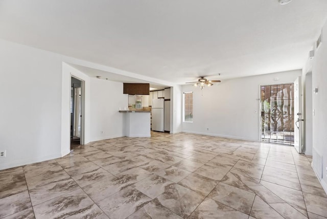 unfurnished living room featuring ceiling fan