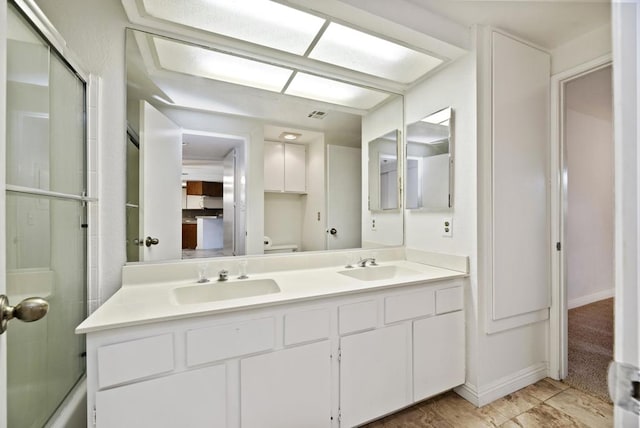 full bathroom with shower / bath combination with glass door, vanity, and toilet