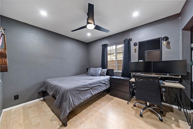 bedroom with ceiling fan and light hardwood / wood-style floors