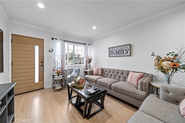 living room featuring crown molding and light hardwood / wood-style floors