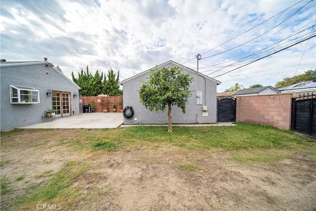 back of property featuring a yard and a patio