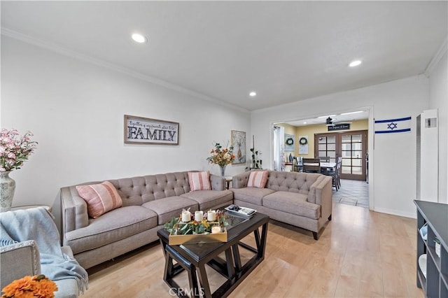 living room featuring ceiling fan, light hardwood / wood-style flooring, and ornamental molding