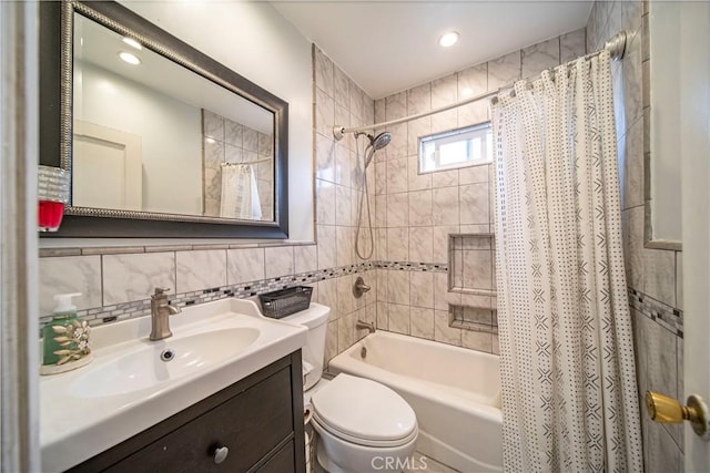 full bathroom with tasteful backsplash, vanity, shower / tub combo with curtain, tile walls, and toilet