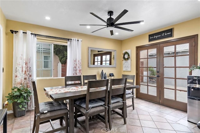 tiled dining area with ceiling fan and french doors