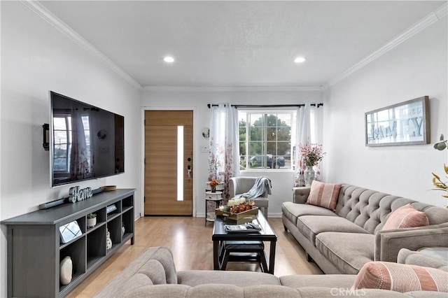 living room with light wood-type flooring and ornamental molding