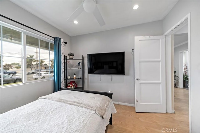 bedroom with ceiling fan and light hardwood / wood-style flooring