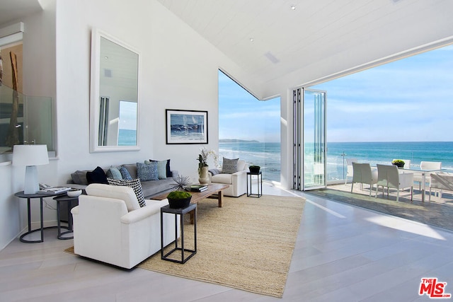 living room with a water view and light hardwood / wood-style floors