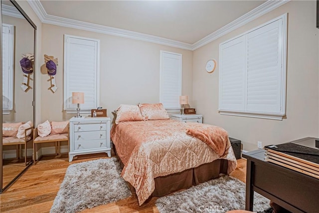 bedroom featuring light hardwood / wood-style flooring and crown molding