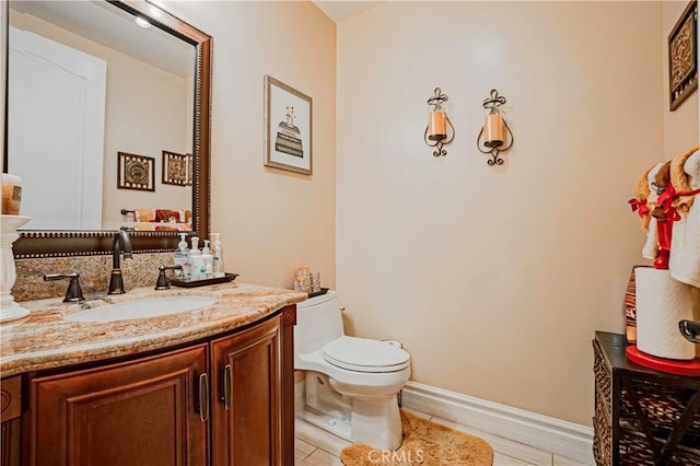 bathroom with hardwood / wood-style floors, vanity, and toilet