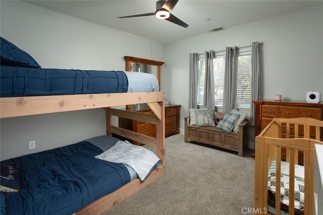 bedroom featuring light colored carpet and ceiling fan