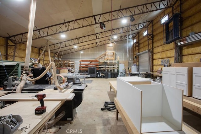 misc room with a workshop area and high vaulted ceiling