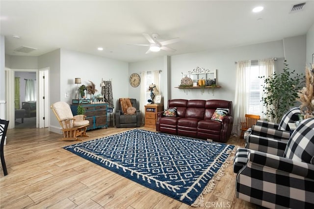 living room with ceiling fan and wood-type flooring