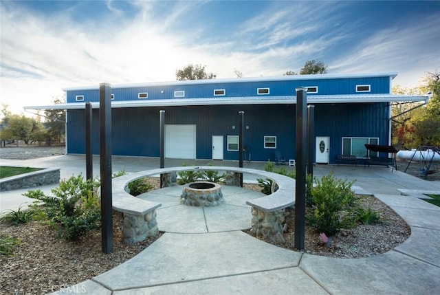 view of property with an outdoor fire pit