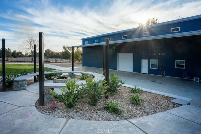 exterior space featuring a patio area and an outdoor fire pit