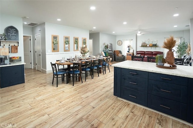 kitchen with ceiling fan and light hardwood / wood-style flooring