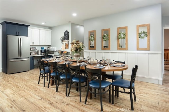 dining space with light hardwood / wood-style floors