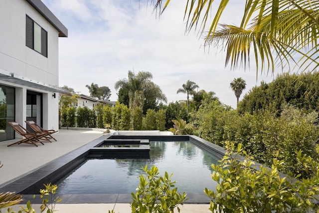 view of pool featuring an in ground hot tub and a patio