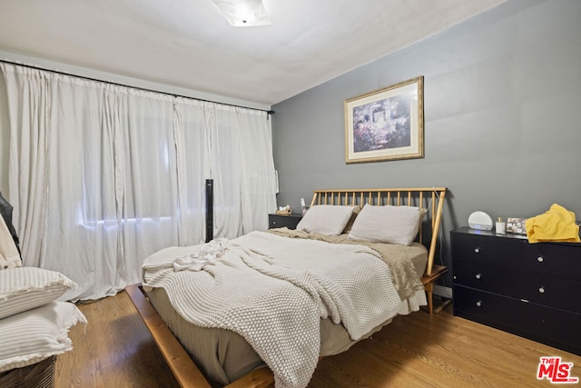 bedroom with hardwood / wood-style flooring