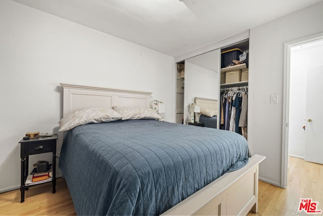 bedroom with a closet and light hardwood / wood-style flooring