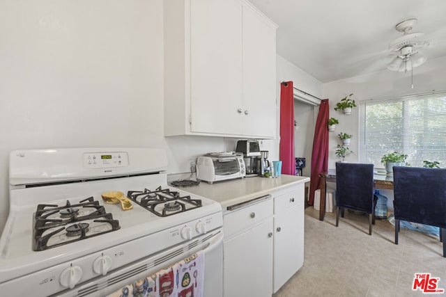 kitchen featuring ceiling fan, white cabinetry, and white range with gas stovetop