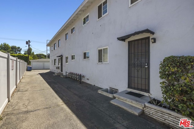 view of side of property with a garage and an outdoor structure