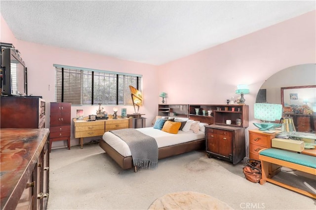 carpeted bedroom with a textured ceiling