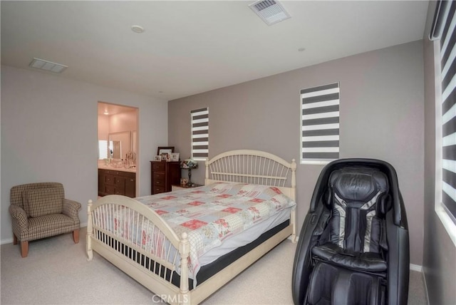 carpeted bedroom featuring ensuite bathroom