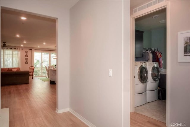 hallway featuring light hardwood / wood-style floors and independent washer and dryer