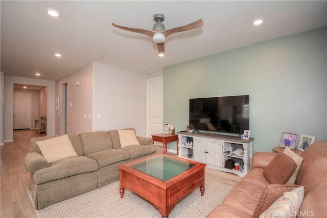 living room featuring light hardwood / wood-style flooring and ceiling fan