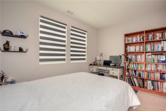 carpeted bedroom featuring multiple windows