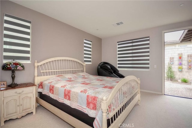 bedroom featuring light carpet and access to outside