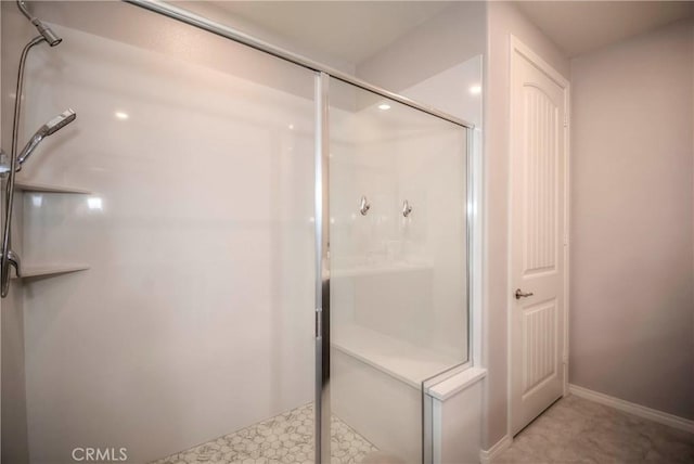 bathroom featuring a shower with shower door