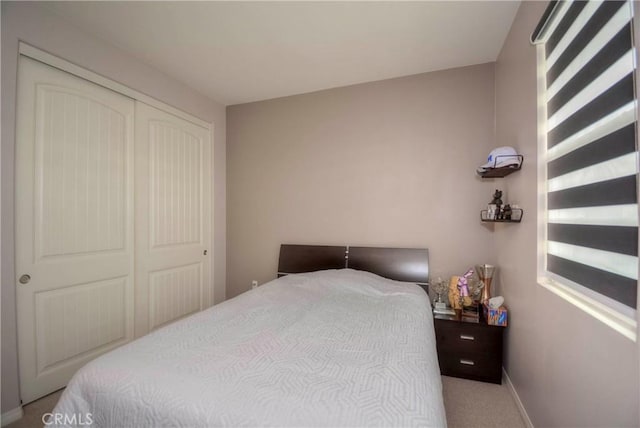 carpeted bedroom with a closet