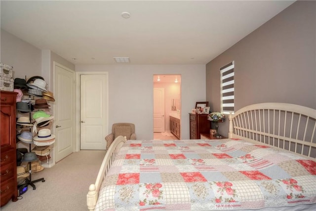 carpeted bedroom with ensuite bathroom