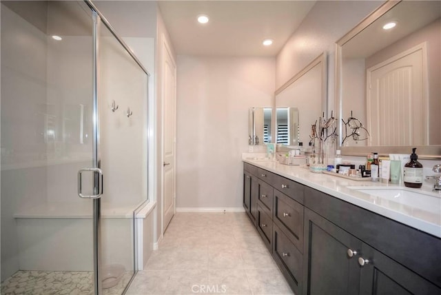 bathroom featuring a shower with door, vanity, and tile patterned flooring