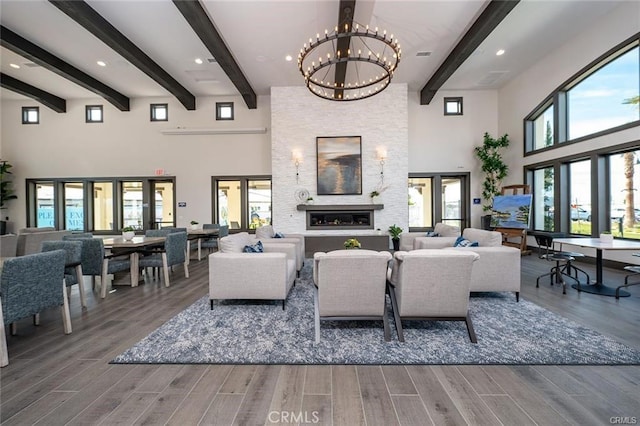 living room with hardwood / wood-style flooring, a wealth of natural light, and a chandelier