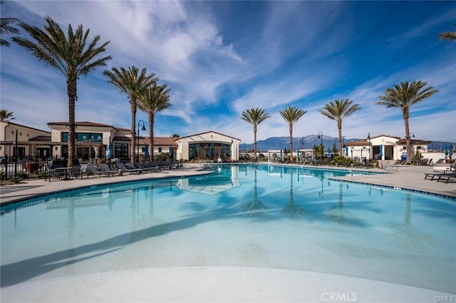 view of pool with a mountain view and a patio