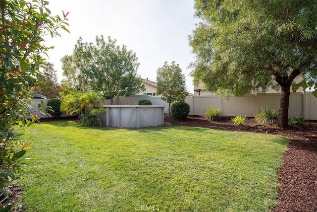 view of yard featuring a fenced in pool