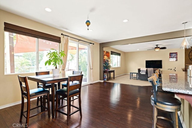 dining room with ceiling fan and dark hardwood / wood-style flooring