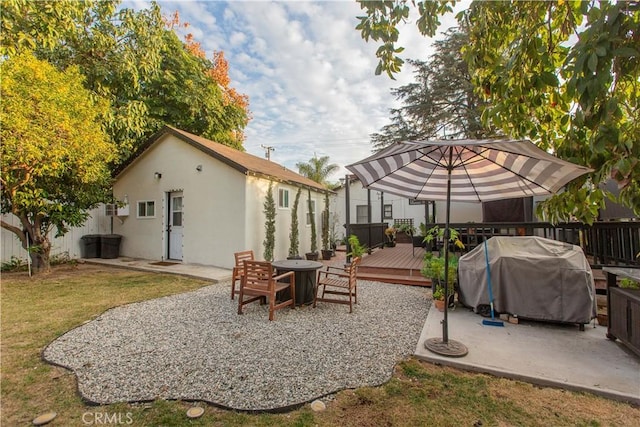 back of house with a deck and a lawn