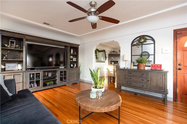 living room with ceiling fan and hardwood / wood-style flooring