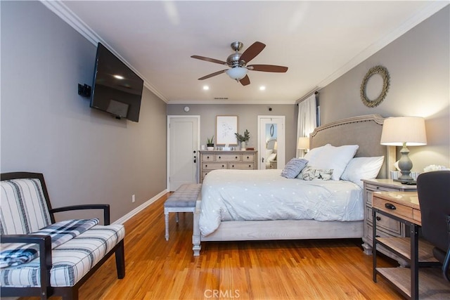 bedroom with light hardwood / wood-style flooring, ceiling fan, and ornamental molding