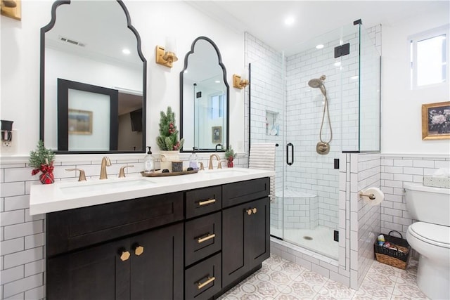 bathroom featuring tile patterned floors, a shower with door, and tile walls