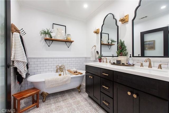 bathroom with vanity, a bathtub, crown molding, and tile walls