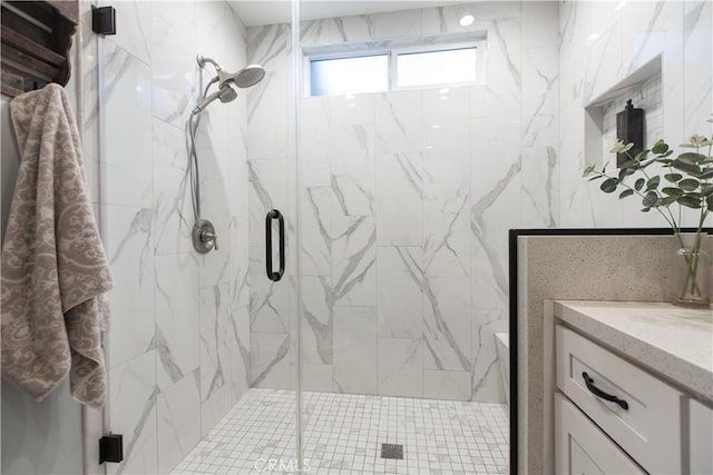 bathroom featuring vanity and a shower with shower door